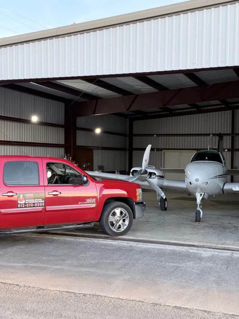 Spade mobile detailing vehicle and aircraft at a hangar.