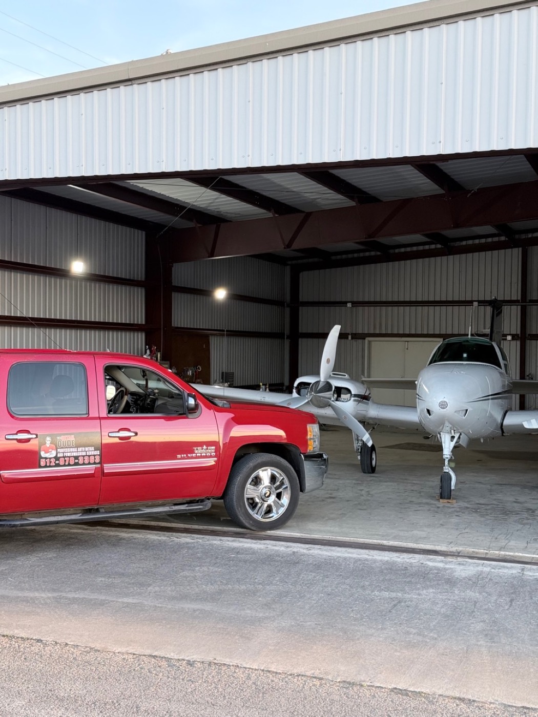 Mobile detailing service truck beside aircraft in Central Texas hangar