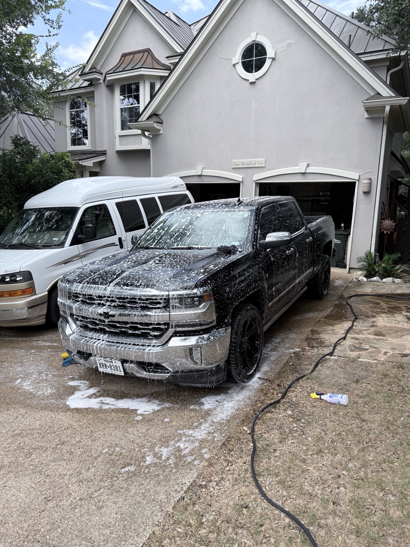 Black Chevrolet Silverado during foam pre-soak front angle