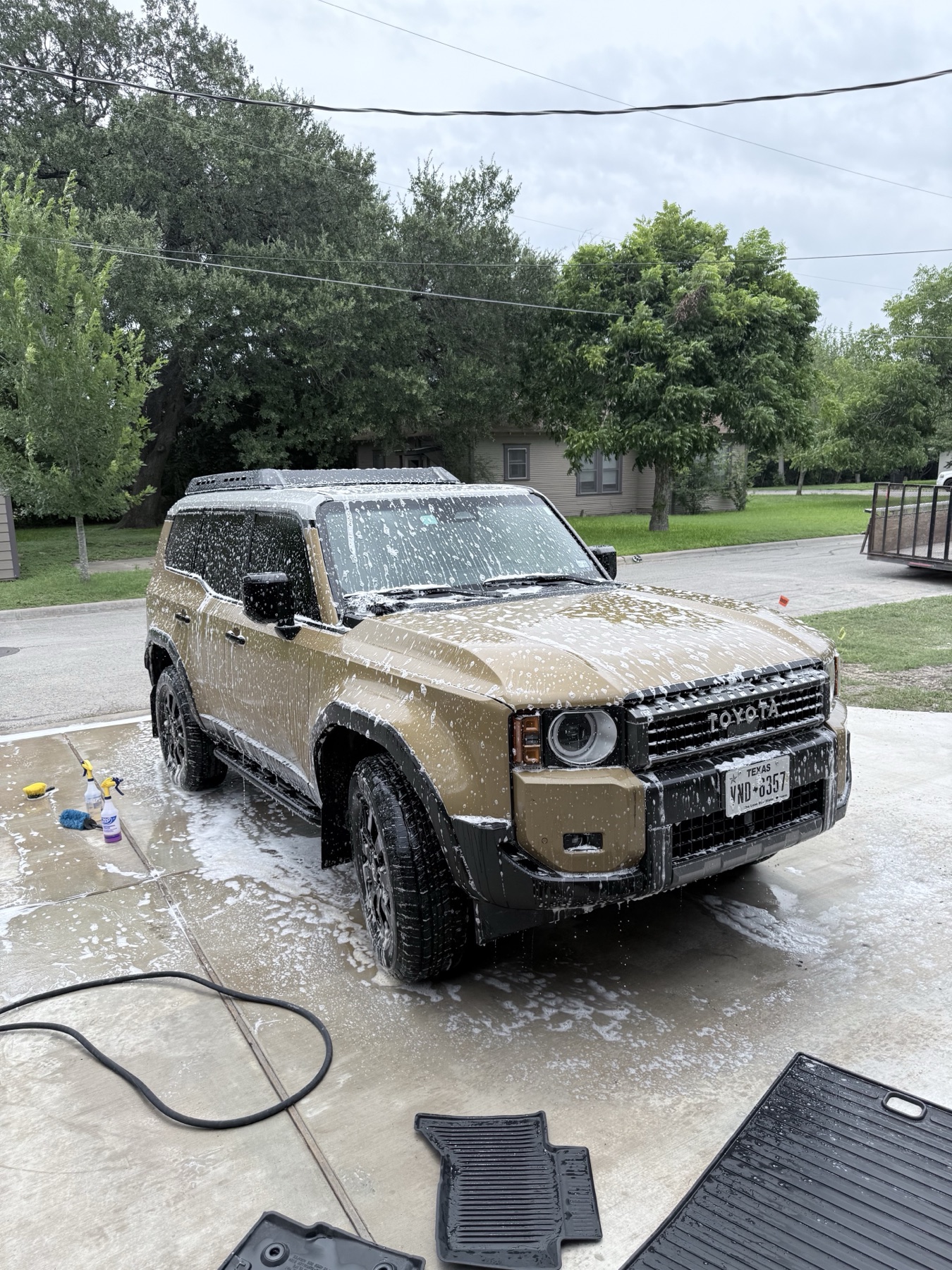 Tan Toyota Land Cruiser covered in foam during mobile detailing in San Marcos TX