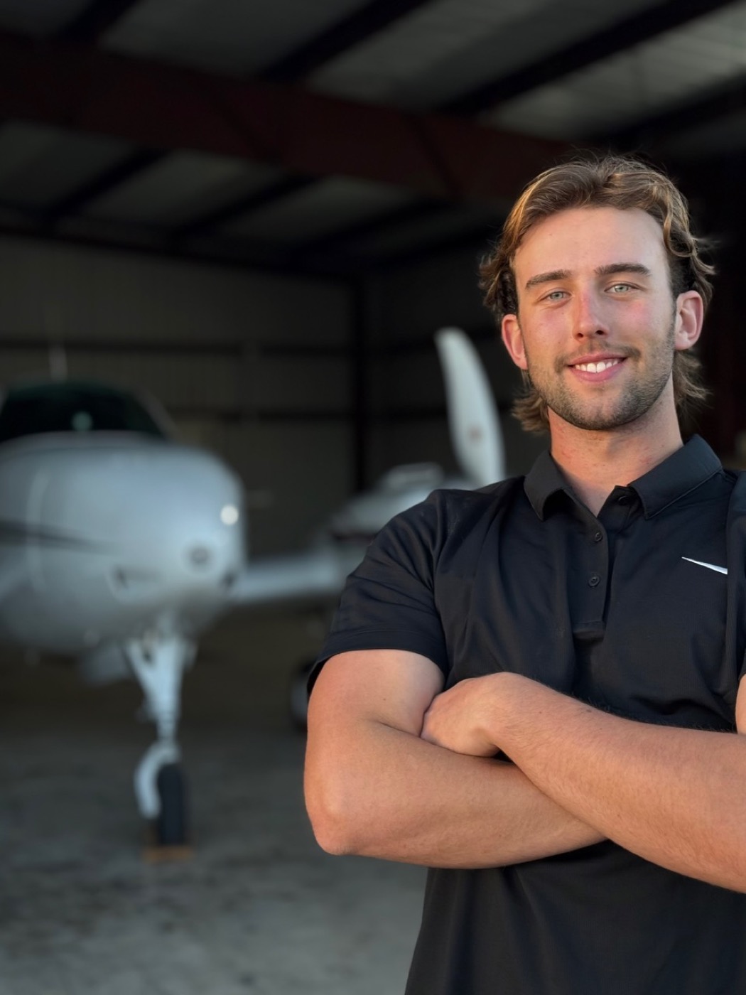 Spade Detail Co owner operator in front of aircraft in hangar